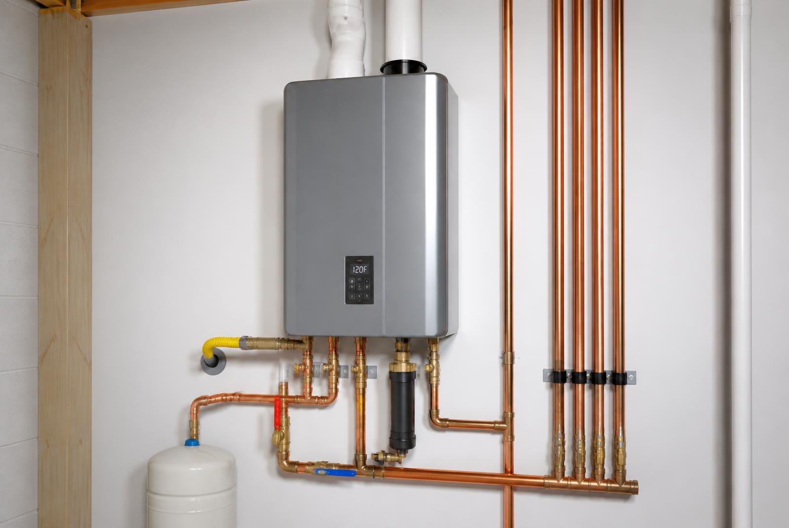 Newly installed tankless water heater with clean copper piping in a home utility room